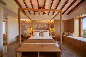 a bedroom with a canopy bed and two windows at Finca Sestelrica in Artá