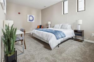 a bedroom with a bed and a table and a desk at 2BR Executive Downtown Apartment by ENVITAE in Detroit
