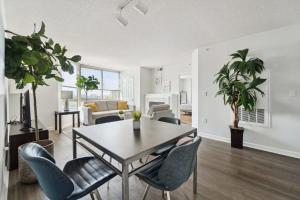 a living room with a dining room table and chairs at 2BR Executive City Suite With Gym & Pool in Arlington