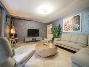 a living room with a couch and a tv at Villa Sun Castle in Kotor