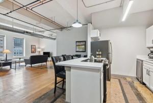 an open kitchen and living room in a building at Spacious & Elegant 2BR Downtown Retreat in Kansas City