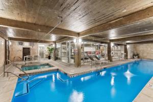 a large pool with blue water in a building at Spacious & Elegant 2BR Downtown Retreat in Kansas City