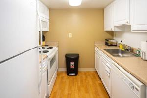 a kitchen with white cabinets and a sink at 2BR Premium A-Location Apartment in Arlington