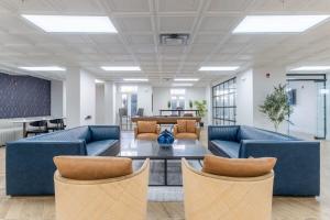an office lobby with blue couches and a table at 3BR Premium Downtown Apartment with Office & Gym in Charlotte