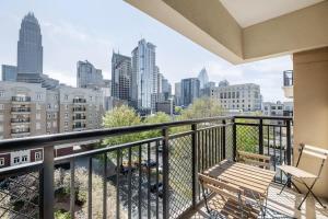 a balcony with a bench and a view of the city at 4B 3BA Premium Family Apartment with Gym in Charlotte