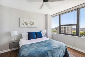 a bedroom with a bed and a large window at 2BR Vibrant South Loop Apartment in Chicago