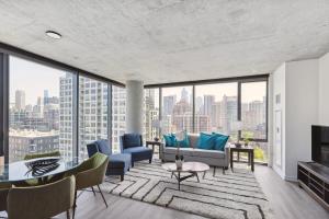 a living room with a view of a city at 2BR Luxury River North Apartment With Wonderful Views in Chicago