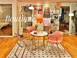 a living room with a table and pink chairs at Boutique,seoul in Seoul