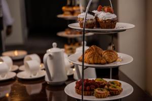 a table with three tiered plates of pastries and cupcakes at Crowne Plaza Nairobi Airport by IHG in Nairobi
