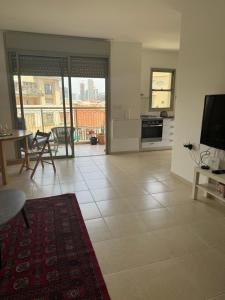 a living room with a view of a kitchen at Near flea market and beach in Tel Aviv