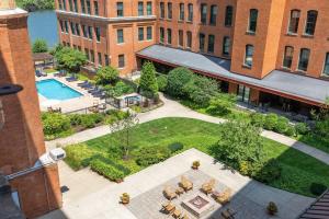 an overhead view of a courtyard with a pool and a building at 2BR 2BA Historic Loft Retreat With Pool in Pittsburgh