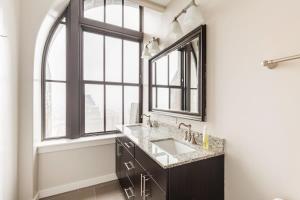 a bathroom with a sink and a large window at 2B 2BA Luxury Downtown Suite Rooftop Deck & Gym in Baltimore