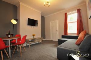a living room with a couch and a table at Luke Stays - Nicholson Terrace in Killingworth