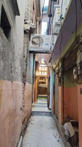 an alley way with a sign that reads bike crawl at Goroomgo BNK Grand Varanasi in Varanasi