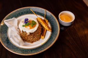 a plate of food with a fried egg and some fries at Crowne Plaza Nairobi Airport by IHG in Nairobi