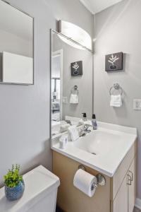 a bathroom with a sink and a mirror at 2BR Modern South Loop Suite With Views & Gym in Chicago