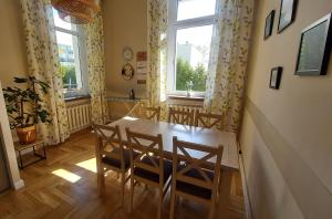 a dining room with a table and chairs and a window at Wanta 2 Kołobrzeg in Kołobrzeg