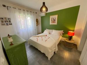 a bedroom with a bed and a green wall at Agence Adjana Resort in Saly Portudal