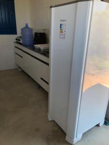 a white refrigerator in a kitchen with a counter at Villa Coral azul in Prado