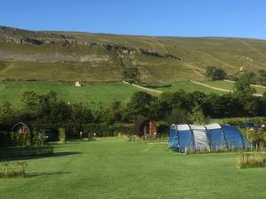 a blue tent in the middle of a field at Wharfe Camp Adults Only Glamping Pod in Kettlewell