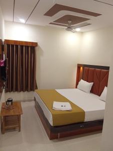 Un pat sau paturi într-o cameră la Hotel Maruti