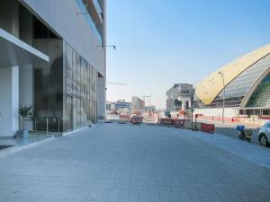 an empty sidewalk in front of a building at Frank Porter - Azizi Aura in Dubai
