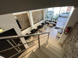 a room with a row of chairs and a fireplace at Hostal Somnis in Suria