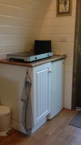 a room with a counter with a laptop on top of it at Wharfe Camp Adults Only Glamping Pod in Kettlewell