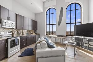 a large kitchen with a couch in the middle of it at 2BR Luxury Apartment Rooftop Pool & Gym in Baltimore