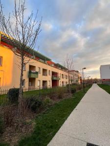 a row of apartment buildings on a street at AXXAM Paris&Versailles Olympics 24 in Bois-dʼArcy