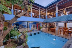 an exterior view of a house with a swimming pool at Matahari Tulamben Resort, Dive & SPA in Tulamben