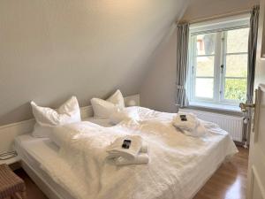 Postel nebo postele na pokoji v ubytování Westerhus Nieblum
