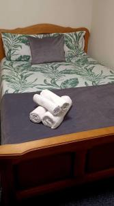 two towels sitting on top of a bed at Casă particulară in Suceava