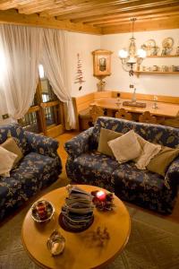 a living room with a couch and a table at Casa Viola in Cortina dʼAmpezzo