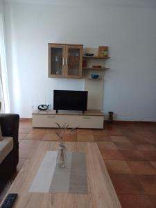 a living room with a tv on a table at Apartmani Afrodita in Crikvenica