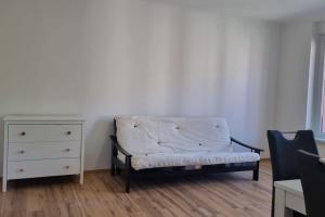 a white couch sitting in a room with a dresser at Charming flat in a quiet central location in Graz