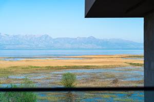 a view from a window of the desert with mountains at Hotel De‘Andros Virpazar in Virpazar