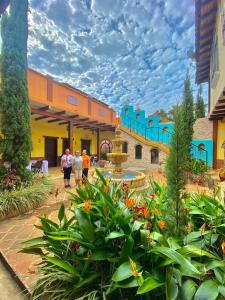 a group of people walking through a courtyard at Casa Colonial San Alejo in Lemos