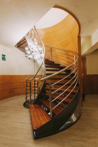 a spiral staircase in a building with a wooden floor at Hotel Zaragoza Plaza in Donostia-San Sebastián