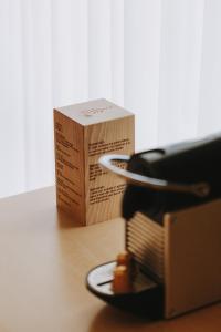 a box sitting next to a toaster on a table at Hotel Zaragoza Plaza in Donostia-San Sebastián