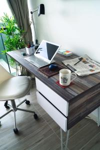 a desk with a laptop computer and a cup of coffee at HOM I Depto Estudio con Vista al Mar y Estacionamiento 1016 in Antofagasta
