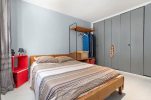 a bedroom with a bed and a red cabinet at Notre cocon mer et montagne in Villelongue-de-la-Salanque