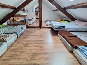 a room with several beds in a attic at Dom Klementa Juga in Lepena