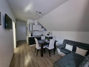 a living room with a table and a couch at Apartment Rosandić in Smoljanac