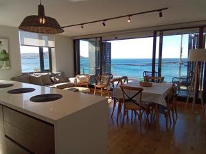 a kitchen and living room with a view of the ocean at Depto 3D2B con 02Parking y Terraza en Puerto Varas Servicio HOM in Puerto Varas