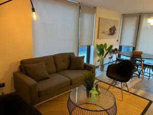 uma sala de estar com um sofá e uma mesa em Familiar Depto con Estacionamiento y Gran Terraza em Puerto Varas