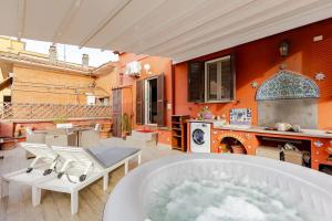 a bath tub in a kitchen with an orange wall at Terrace of Love in Rome