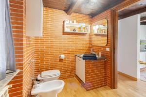 a brick bathroom with a toilet and a sink at Terrace of Love in Rome +51 photos