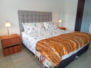 a bedroom with a large bed with two night stands at Mejor Ubicación de Puerto Varas con Estacionamiento Servicio HOM in Puerto Varas