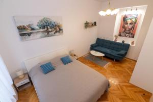 a small bedroom with a bed and a couch at Teatro apartment in Rijeka